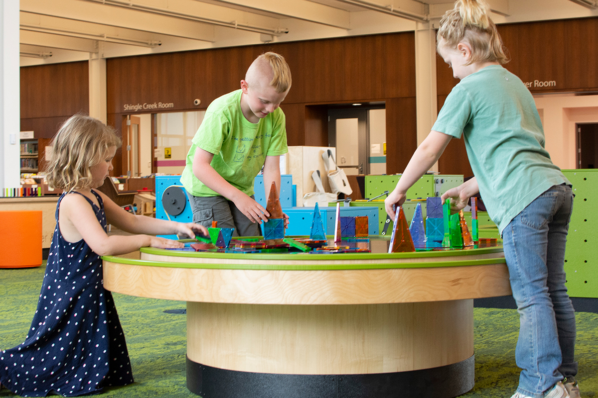 children playing with a multi-activity table